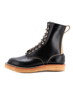 Black eight inch boot with tan backstay and vibram foam wedge sole.